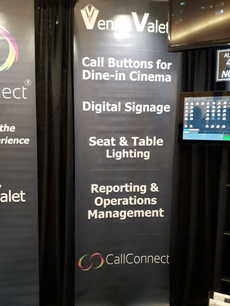 CinemaCon vendor sign promoting call buttons in cinema seating.