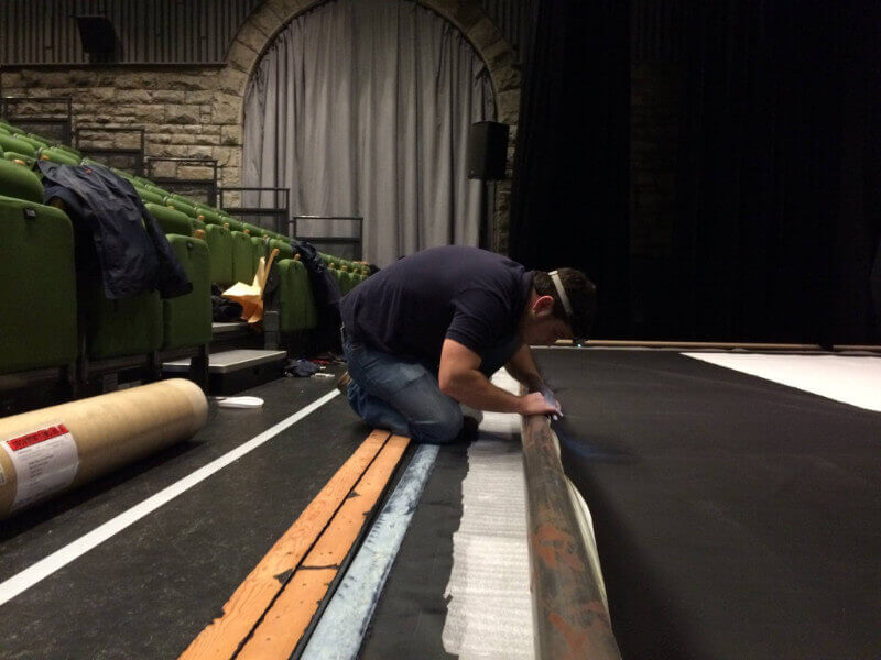 A Camstage worker gets the roller screen ready at Wyeside